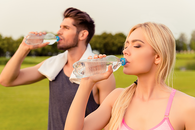 A man and a woman drinking water
